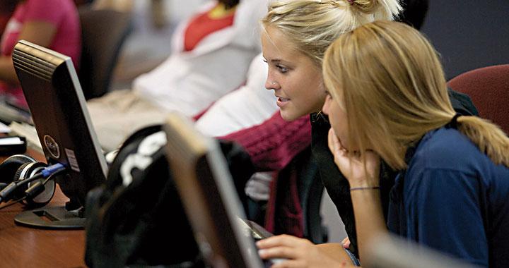 Students looking at a computer